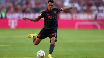 MUNICH, GERMANY - AUGUST 14:  Jamal Musiala of Muenchen runs with the ball during the Bundesliga match between FC Bayern München and VfL Wolfsburg at Allianz Arena on August 14, 2022 in Munich, Germany. (Photo by Lars Baron/Getty Images)
