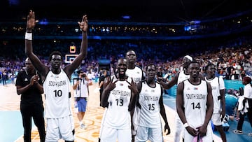 (From L) South Sudan's #10 Jt Thor, South Sudan's #13 Majok Deng, South Sudan's #26 Sunday Dech and South Sudan's #14 Peter Jok celebrate at the end of the men's preliminary round group C basketball match between South Sudan and Puerto Rico during the Paris 2024 Olympic Games at the Pierre-Mauroy stadium in Villeneuve-d'Ascq, northern France, on July 28, 2024. (Photo by Sameer Al-Doumy / AFP)