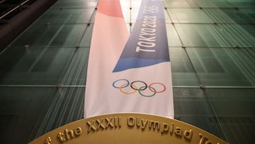 This picture shows a large-scale reproduction of the Tokyo 2020 Olympic Games gold medal as part of the Olympic Agora event at Mitsui Tower in Tokyo on July 14, 2021. (Photo by Philip FONG / AFP)