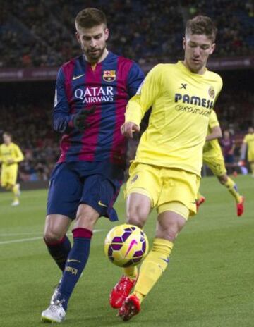 Gerard Piqué y Luciano Vietto.