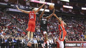 Jan 29, 2019; Houston, TX, USA; Houston Rockets guard James Harden (13) splits the defense of New Orleans Pelicans guard Kenrich Williams (34) and forward Darius Miller (21) in the second quarter at Toyota Center. Mandatory Credit: Thomas B. Shea-USA TODAY Sports