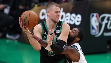 BOSTON, MASSACHUSETTS - JUNE 09: Kristaps Porzingis #8 of the Boston Celtics is defended by Kyrie Irving #11 of the Dallas Mavericks during the fourth quarter in Game Two of the 2024 NBA Finals at TD Garden on June 09, 2024 in Boston, Massachusetts. NOTE TO USER: User expressly acknowledges and agrees that, by downloading and or using this photograph, User is consenting to the terms and conditions of the Getty Images License Agreement.   Adam Glanzman/Getty Images/AFP (Photo by Adam Glanzman / GETTY IMAGES NORTH AMERICA / Getty Images via AFP)