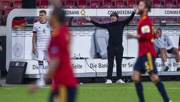 Germany head coach Joachim Low, background, gestures during the UEFA Nations League soccer match between Germany and Spain at the Mercedes-Benz Arena stadium in Stuttgart, Germany, Thursday, Sept. 3, 2020. (AP Photo/Matthias Schrader)