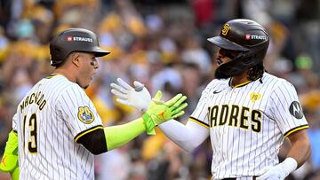 Oct 1, 2024; San Diego, California, USA; San Diego Padres outfielder Fernando Tatis Jr. (23) reacts with third base Manny Machado (13) after hitting a two run home run against the Atlanta Braves during the first inning in game one of the Wildcard round for the 2024 MLB Playoffs at Petco Park. Mandatory Credit: Denis Poroy-Imagn Images