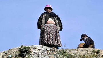 An indigenous woman looks on at a low-income area in El Alto, on May 22, 2020, amid the new coronavirus pandemic. (Photo by AIZAR RALDES / AFP)