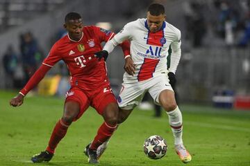 David Alaba and Kylian Mbappe vie for the ball during the UEFA Champions League quarter-final first leg between FC Bayern Munich and Paris Saint-Germain (PSG) in Munich on April 7, 2021. (Photo by Christof STACHE / AFP)