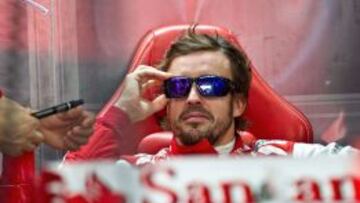 Ferrari driver Fernando Alonso of Spain waits in in the team garage during the first practice session of the Formula One Korean Grand Prix in Yeongam on October 4, 2013. AFP PHOTO/ Prakash SINGH