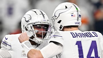 MINNEAPOLIS, MINNESOTA - DECEMBER 16: Sam Darnold #14 celebrates with Justin Jefferson #18 of the Minnesota Vikings after a first quarter touchdown against the Chicago Bears at U.S. Bank Stadium on December 16, 2024 in Minneapolis, Minnesota.   Stephen Maturen/Getty Images/AFP (Photo by Stephen Maturen / GETTY IMAGES NORTH AMERICA / Getty Images via AFP)
