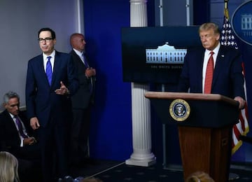 US President Donald Trump listens to Treasury Secretary Steven Mnuchin in the Brady Briefing Room of the White House in Washington.