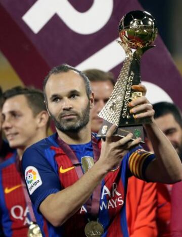 Andrés Iniesta holds the trophy aloft