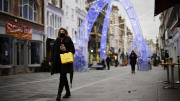 A pedestrian wearing a face mask the COVID-19 pandemic, walks along a street in central London on December 22, 2020. - UK government borrowing continued to soar in November on emergency action to support the virus-hit economy which nevertheless rebounded stronger than expected in the third quarter, official data showed Tuesday. Government borrowing last month hit xA331.6 billion ($41.8 billion, 34.2 billion euros), a record for November -- taking public sector net debt to xA32.1 trillion, the Office for National Statistics said in a statement. (Photo by Tolga Akmen / AFP)