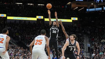 San Antonio Spurs forward Julian Champagnie (30) shoots over New York Knicks guard Mikal Bridges (25) in the first half at Frost Bank Center.