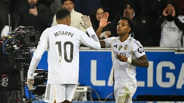 Real Madrid's Brazilian forward #11 Rodrygo celebrates scoring his team's second goal with Real Madrid's French forward #10 Kylian Mbappe during the Spanish league football match between Deportivo Alaves and Real Madrid CF at the Mendizorroza stadium in Vitoria on December 14, 2025. (Photo by ANDER GILLENEA / AFP)