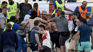 This file photo taken on June 11, 2016 shows groups of supporters fighting at the end of the Euro 2016 group B football match between England and Russia at the Stade Velodrome in Marseille