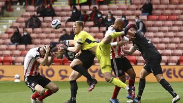 Sheffield United's Chris Basham, left, collides with Burnley's James Tarkowski during the English Premier League soccer match between Sheffield United and Burnley at Bramall Lane, Sheffield, England, Sunday, May 23, 2021. (Tim Goode/Pool Photo v