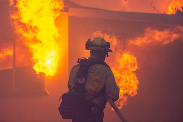 Un bombero lucha contra el incendio de Palisades mientras arde durante una tormenta de viento en el lado oeste de Los ?ngeles.