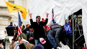 A man, identified as Ryan Kelley in a sworn statement by an FBI agent, gestures as supporters of U.S. President Donald Trump make their way past barriers at the U.S. Capitol during a protest against the certification of the 2020 U.S. presidential election results by the U.S. Congress, in Washington, U.S., January 6, 2021. REUTERS/Jim Urquhart