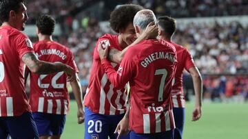 Atletico Madrid's French forward #07 Antoine Griezmann celebrates with Atletico Madrid's Belgian midfielder #20 Axel Witsel scoring his team's first goal during the Spanish Liga football match between Rayo Vallecano de Madrid and Club Atletico de Madrid at the Vallecas stadium in Madrid on August 28, 2023. (Photo by Thomas COEX / AFP)