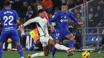 Real Madrid's English midfielder #5 Jude Bellingham vies with Getafe's British forward #12 Mason Greenwood during the Spanish league football match between Getafe CF and Real Madrid CF at the Coliseum Alfonso Perez stadium in Getafe on February 1, 2024. (Photo by Pierre-Philippe MARCOU / AFP)