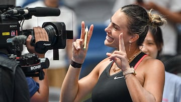 Belarus� Aryna Sabalenka poses after signing on the screen of the television camera at the end of her women�s singles quarterfinal match against Kazakhstan's Elena Rybakina at the Wuhan Open tennis tournament in Wuhan, Central China�s Hubei province on October 10, 2025. (Photo by ADEK BERRY / AFP)