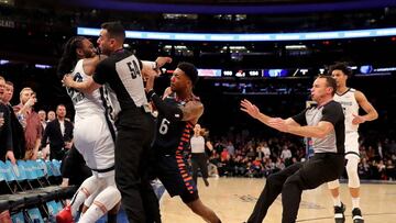NEW YORK, NEW YORK - JANUARY 29: The referees try to break up a fight between Jae Crowder #99 of the Memphis Grizzlies and Elfrid Payton #6 of the New York Knicks in the final minute of the game at Madison Square Garden on January 29, 2020 in New York Cit