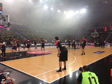 Los jugadores del Bilbao Basket lanza con el humo negro en la zona superior.