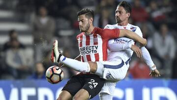 Argentina's Estudiantes de La Plata forward Lucas Melano (L) vies for the ball with Paraguay's Nacional midfielder Jonathan Santana during their Copa Sudamericana round before the quarterfinals second leg football match at Ciudad de La Plata sta