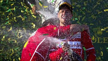 ZSN078. Melbourne (Australia), 26/03/2017.- Luigi Fraboni (L), Ferrari Head of Engine Trackside Operations, hugs winner German Formula One driver Sebastian Vettel of Scuderia Ferrari (R) celebrate with champagne on the podium after the 2017 Formula One Grand Prix of Australia at the Albert Park circuit in Melbourne, Australia, 26 March 2017. Vettel won the race (F&oacute;rmula Uno) EFE/EPA/DIEGO AZUBEL