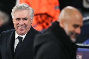 Manchester City's Spanish manager Pep Guardiola (L) and Real Madrid's Italian coach Carlo Ancelotti react at the start of the UEFA Champions League football match between Manchester City and Real Madrid at the Etihad Stadium in Manchester, north west England, on February 11, 2025. (Photo by Oli SCARFF / AFP)