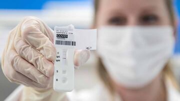 A medical staff member from Barrand laboratory holds a positive COVID-19 serological test in Colmar, eastern France, on April 14, 2020, on the 29th day of a strict lockdown in France to stop the spread of COVID-19 (novel coronavirus). (Photo by SEBASTIEN 