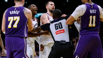 LOS ANGELES, CALIFORNIA - NOVEMBER 25: Kris Dunn #8 of the LA Clippers yells at Jaxson Hayes #11 of the Los Angeles Lakers as referee James Williams #60 and Ivica Zubac #40 intervene in front of Luka Doncic #77 during a 135-118 Lakers win at Crypto.com Arena on November 25, 2025 in Los Angeles, California. Harry How/Getty Images/AFP NOTE TO USER: User expressly acknowledges and agrees that, by downloading and or using this photograph, User is consenting to the terms and conditions of the Getty Images License Agreement. (Photo by Harry How/Getty Images) (Photo by Harry How / GETTY IMAGES NORTH AMERICA / Getty Images via AFP)