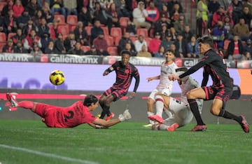 Tijuana's goalkeeper # Jose Rodriguez (L) fails to stop a goal from Toluca's Portuguese forward Joao Dias (C) during the Liga MX Clausura football league match between Tijuana and Toluca at Caliente stadium in Tijuana, Baja California, Mexico on January 10, 2025. (Photo by Guillermo Arias / AFP)