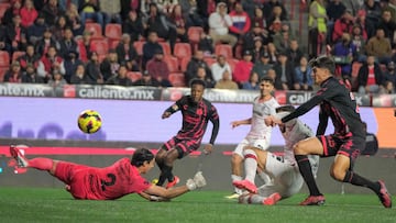 Tijuana's goalkeeper # Jose Rodriguez (L) fails to stop a goal from Toluca's Portuguese forward Joao Dias (C) during the Liga MX Clausura football league match between Tijuana and Toluca at Caliente stadium in Tijuana, Baja California, Mexico on January 10, 2025. (Photo by Guillermo Arias / AFP)