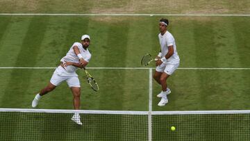 LONDON, ENGLAND - JULY 03: Juan Sebastian Cabal (R) plays a volley with partner Robert Farah of Colombia against Radu Albot of Moldova and Nikoloz Basilashvili of Georgia during their Men's Doubles Third Round match on day seven of The Championships Wimbledon 2022 at All England Lawn Tennis and Croquet Club on July 03, 2022 in London, England. (Photo by Julian Finney/Getty Images)