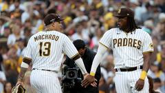 SAN DIEGO, CALIFORNIA - OCTOBER 19: Manny Machado #13 of the San Diego Padres and Josh Bell #24 celebrate defeating the Philadelphia Phillies 8-5 in game two of the National League Championship Series at PETCO Park on October 19, 2022 in San Diego, California.   Harry How/Getty Images/AFP