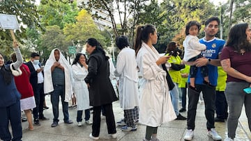 People wait outside their homes and buildings after an alarm sounded warning of a tremor, in Mexico City, Mexico, January 2, 2026. REUTERS/Henry Romero