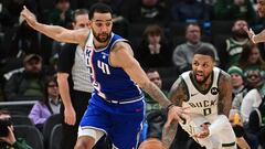 Milwaukee Bucks guard Damian Lillard (0) passes the ball away from Sacramento Kings forward Trey Lyles (41) in overtime at Fiserv Forum.