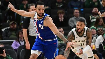 Milwaukee Bucks guard Damian Lillard (0) passes the ball away from Sacramento Kings forward Trey Lyles (41) in overtime at Fiserv Forum.