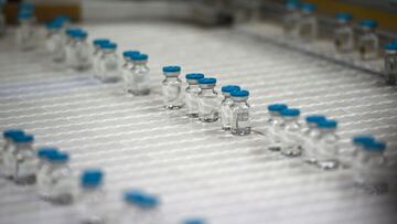 This picture taken on April 22, 2021, in Poce-sur-Cisse, Central France, shows bottles of diluent on the production line inside the pharmaceutical plant Fareva. - Fareva was chosen as the main supplier of the candidate RNA messenger vaccine from the Germa