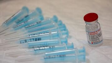 A vial containing doses of the Moderna vaccine against the coronavirus disease (COVID-19) and empty syringes are seen at a vaccination centre in Ronda, Spain June 9, 2021. REUTERS/Jon Nazca