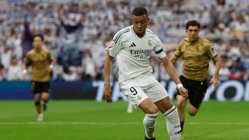 Real Madrid's French forward #09 Kylian Mbappe dribbles the ball during the Spanish league football match between Real Madrid CF and Real Sociedad at Santiago Bernabeu Stadium in Madrid on May 24, 2025. (Photo by Pierre-Philippe MARCOU / AFP)