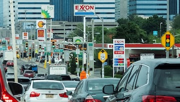 FILE PHOTO: People drive their cars near Exxon and BP gas stations at the exit of the Holland Tunnel during the start of the Memorial Day weekend, under rising gas prices and record inflation, in Newport, New Jersey, U.S., May 27, 2022. REUTERS/Eduardo Munoz/File Photo