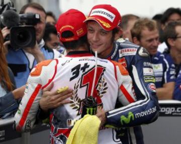 Honda MotoGP rider Marc Marquez (L) of Spain is congratulated by Yamaha MotoGP rider Valentino Rossi of Italy after the 2014 world champion at the Japanese Grand Prix at the Twin Ring Motegi circuit in Motegi, north of Tokyo October 12, 2014. Marquez retained his MotoGP world title with a second place finish at his team Honda's home Motegi circuit in the Japanese Grand Prix on Sunday.  REUTERS/Toru Hanai (JAPAN)