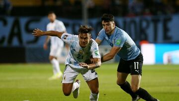 Soccer Football - World Cup - South American Qualifiers - Uruguay v Argentina - Estadio Campeon del Siglo, Montevideo, Uruguay - November 12, 2021 Argentina's Paulo Dybala in action with Uruguay's Joaquin Piquerez Pool via REUTERS/Ernesto Ryan