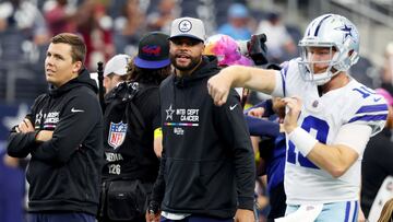 ARLINGTON, TEXAS - OCTOBER 02: Offensive coordinator Kellen Moore of the Dallas Cowboys and Dak Prescott #4 of the Dallas Cowboys watches Cooper Rush #10 of the Dallas Cowboys warm up before their game against the Washington Commanders at AT&T Stadium on October 02, 2022 in Arlington, Texas.   Richard Rodriguez/Getty Images/AFP