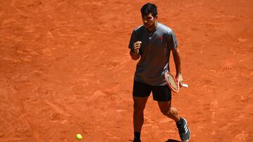 Chile's Christian Garin celebrates winning a point against Russia's Daniil Medvedev during their 2021 ATP Tour Madrid Open tennis tournament singles match at the Caja Magica in Madrid on May 6, 2021. (Photo by GABRIEL BOUYS / AFP)