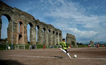 20. Campo de fútbol callejero entre las ruinas de un acueducto en Roma.