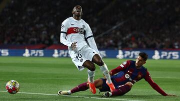 Paris Saint-Germain's French forward #10 Ousmane Dembele reacts next to Barcelona's Portuguese defender #02 Joao Cancelo during the UEFA Champions League quarter-final second leg football match between FC Barcelona and Paris SG at the Estadi Olimpic Lluis Companys in Barcelona on April 16, 2024. (Photo by FRANCK FIFE / AFP)