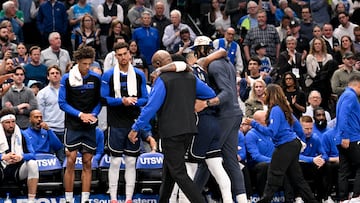 Mar 3, 2025; Dallas, Texas, USA; Dallas Mavericks guard Kyrie Irving (11) is helped off the court by forward Anthony Davis (3) during the second quarter against the Sacramento Kings at the American Airlines Center. Mandatory Credit: Jerome Miron-Imagn Images