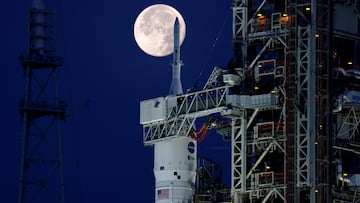 A full moon, known as the "Strawberry Moon" is shown with NASA's next-generation moon rocket, the Space Launch System (SLS) Artemis 1, at the Kennedy Space Center in Cape Canaveral, Florida.